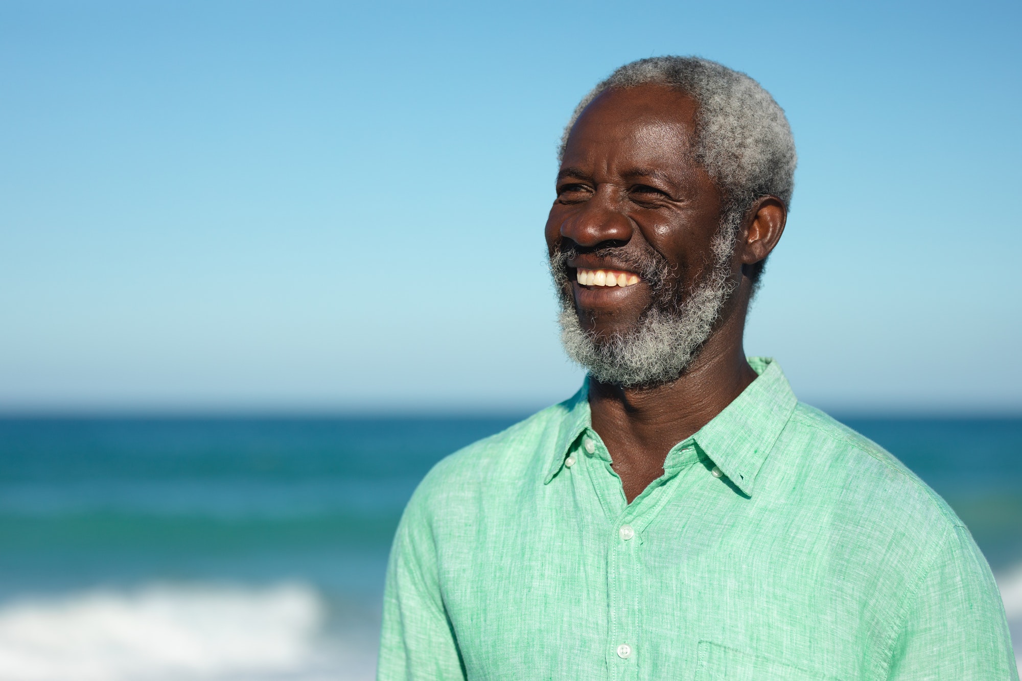 Old man smiling at the beach