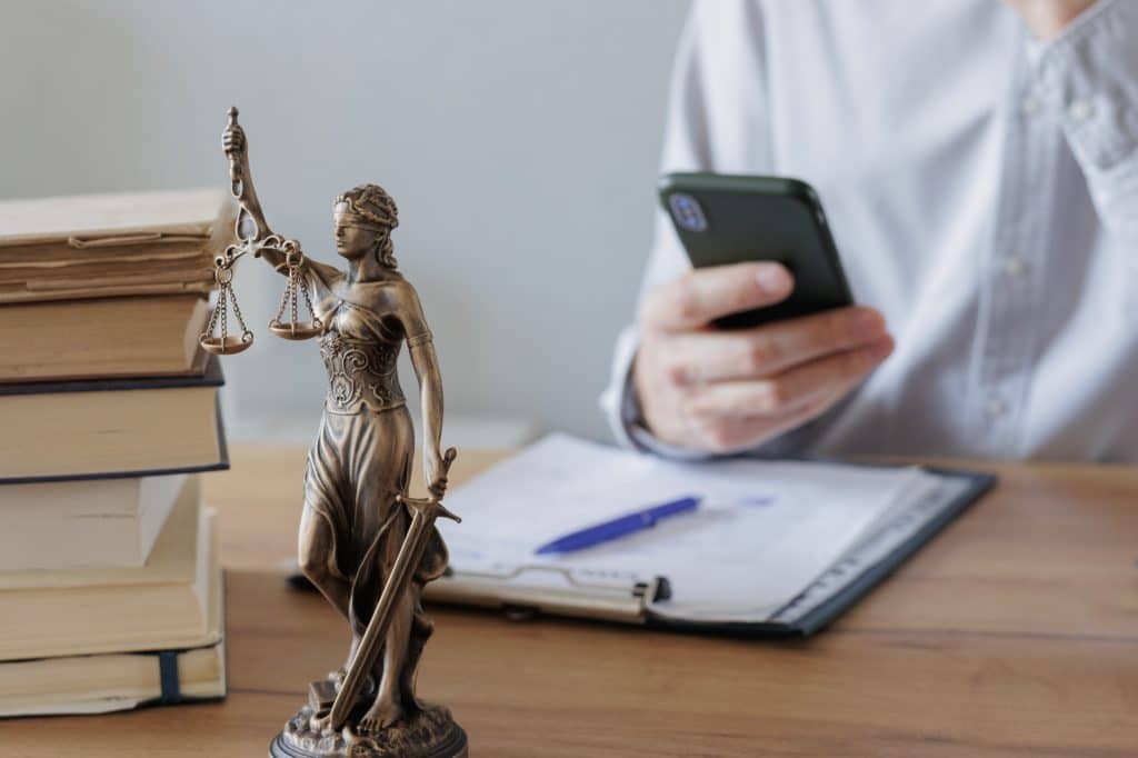 legal advice in the office or online. a European man checks the contract and makes notes in notebook