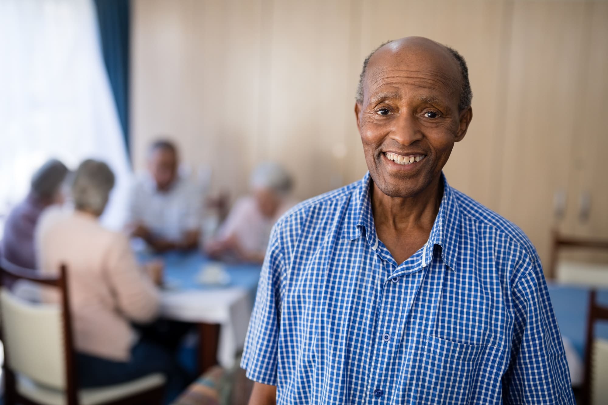 Portrait of smiling senior male at nursing home