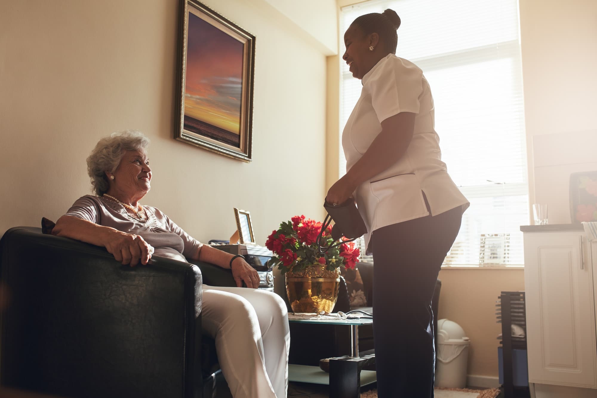 Senior woman at home with female caregiver